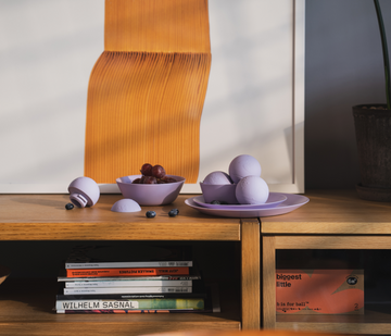 purple b is for ball® placed on purple plates in a tranquil designer livingroom