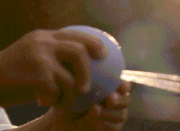 A child squirting water with a purple b is for ball®