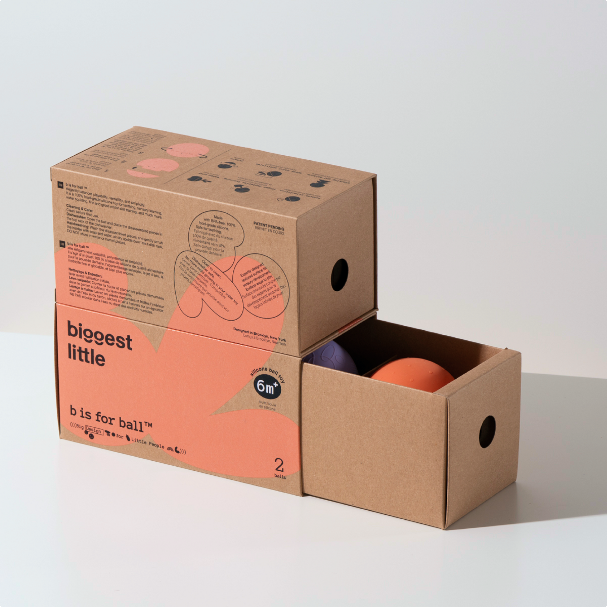 Two B is for Ball toys in orange and purple in a drawer box
