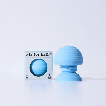Blue sensory baby ball with packaging labeled 'b is for ball' on a light gray background