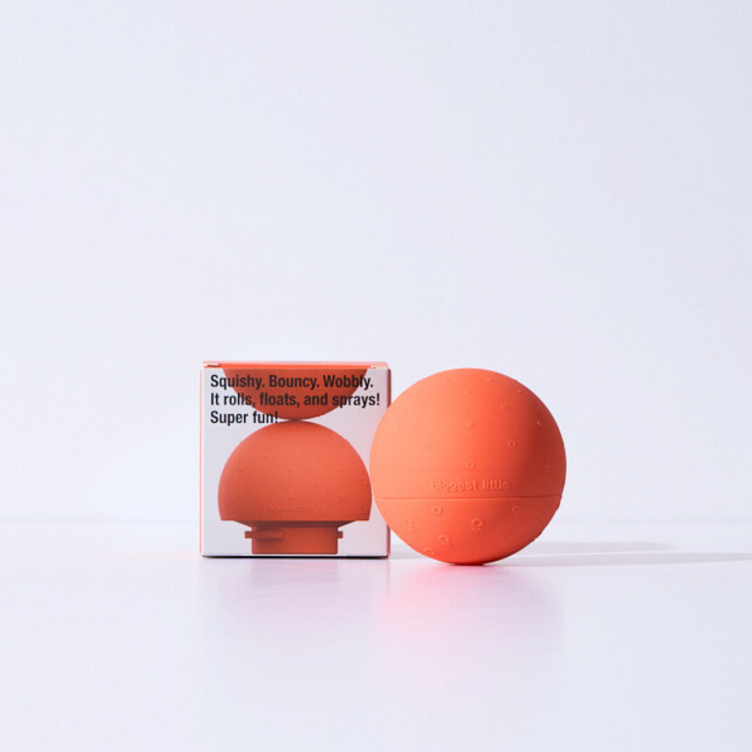 Orange sensory baby ball with packaging on a white background
