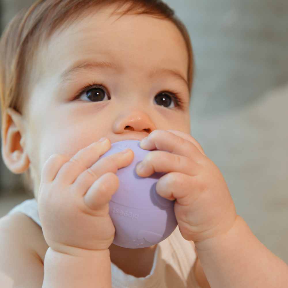 Baby using B is for Ball toy as a teether for sensory play